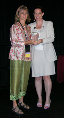 Carey Smith (left) receives the Teacher of the Year Award from AMTA President Judy Stahl